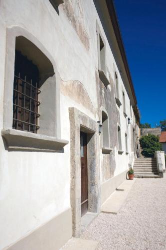 a white building with a window and a door at Relais Villa Giusso in Vico Equense