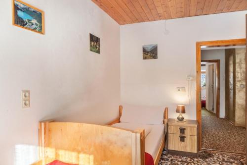 a bedroom with a bed and a table and a mirror at Ferienhaus Wechner in Häselgehr