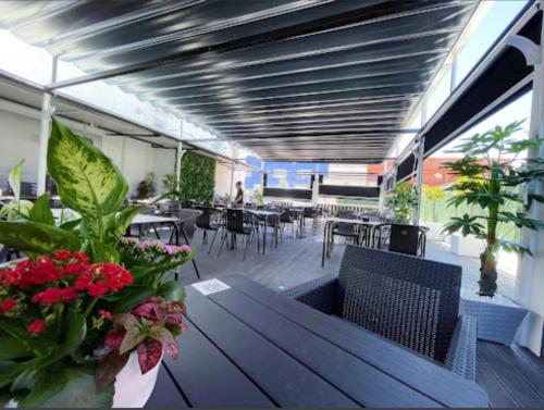 a dining room with tables and chairs and flowers at Hotel El Molino in Ciudad Real