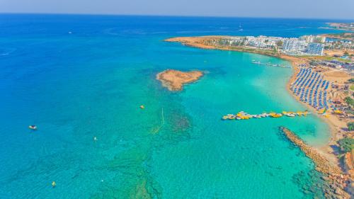 an aerial view of a beach and the ocean at Constantinos the Great Beach Hotel in Protaras