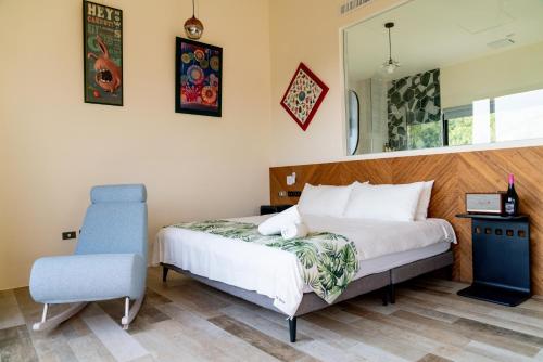 a bedroom with a bed and a blue chair at Shark B&B in Hengchun