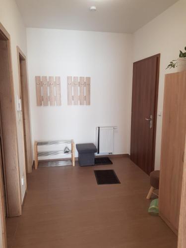 a room with a hallway with a chair and a door at Barbora in Kašperské Hory