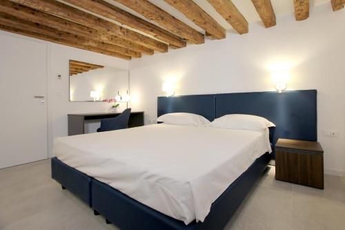 a bedroom with a large bed and a desk at Residence Modern Art in Venice