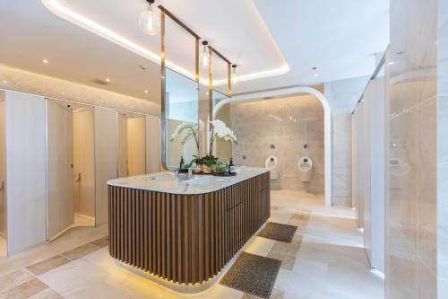 une salle de bain avec un lavabo et un grand miroir dans l'établissement Sky River, Luxury Infinity, Center Chiang Mai, à Chiang Mai