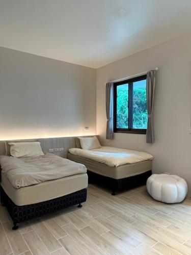 宜蘭市にあるLucid Dream清醒夢民宿のベッドルーム1室(ベッド2台、窓付)