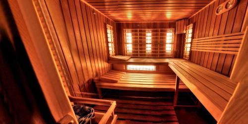 a small wooden sauna with a window in it at Penzion Tillerova vila in Lázně Bohdaneč