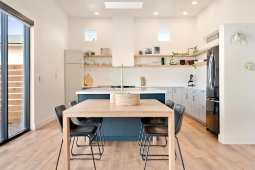 a kitchen with a wooden table and chairs at Back Haus - Views, Dark Skies and Fire Pit! home in Joshua Tree