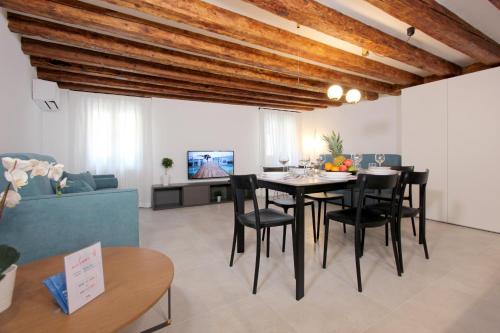 a dining room and living room with a table and chairs at Residence Modern Art in Venice