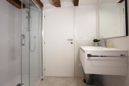 a white bathroom with a sink and a shower at Residence Modern Art in Venice