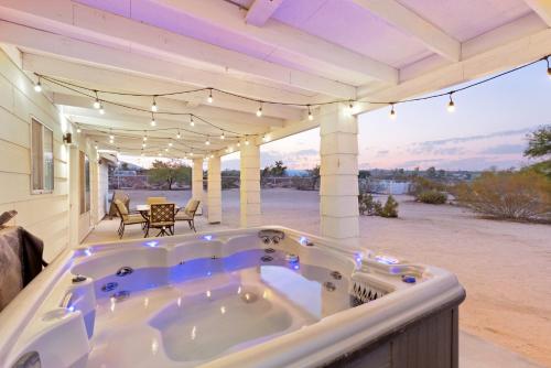 a jacuzzi tub on the back of a house at Golden Desert Ranch - Hot Tub, Fire Pit and BBQ! home in Joshua Tree
