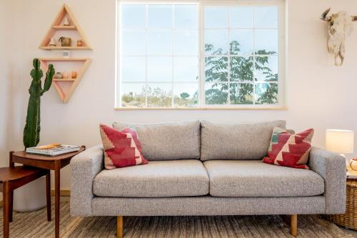 a living room with a couch and a table at Flamingo Ranch - Dreamy Desert Design with Hot Tub home in Pioneertown