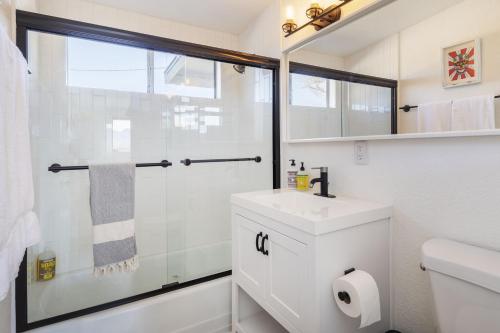a white bathroom with a shower and a sink at Walpi Ranch - Joshua Tree Getaway with Hot Tub, Fire Pit & BBQ! home in Joshua Tree