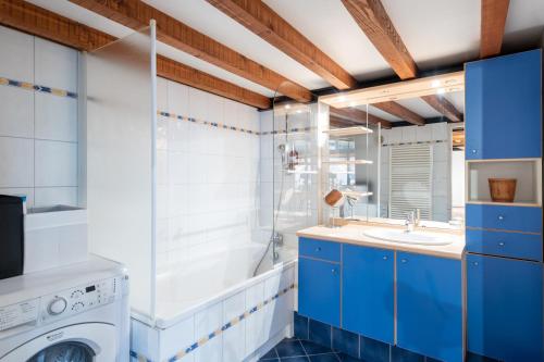 une salle de bain avec une machine à laver et un lavabo dans l'établissement L'Atelier de Pierre - Charmant T4 à la Croix Rousse, à Lyon