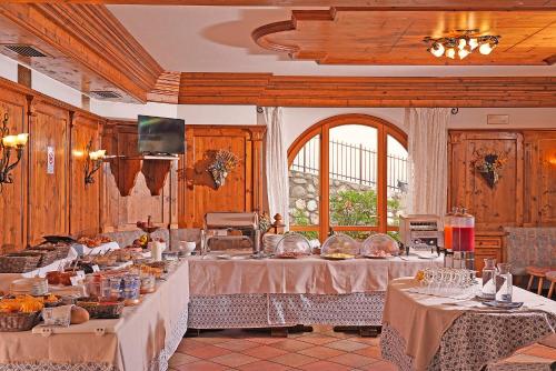 a large room with tables with food on them at Garnì Hotel Tignale, GTSGroup in Tignale