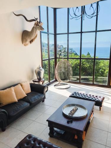 a living room with a couch and a table at Villa Seaview in Knysna