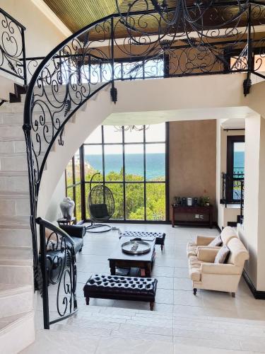 a living room with a staircase with a view of the ocean at Villa Seaview in Knysna