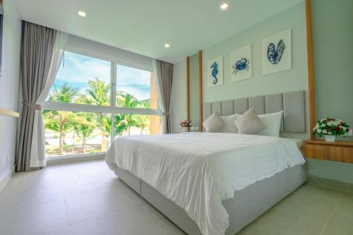 a bedroom with a large bed and a large window at Lazure Pool Villa - Koh Chang in Ko Chang