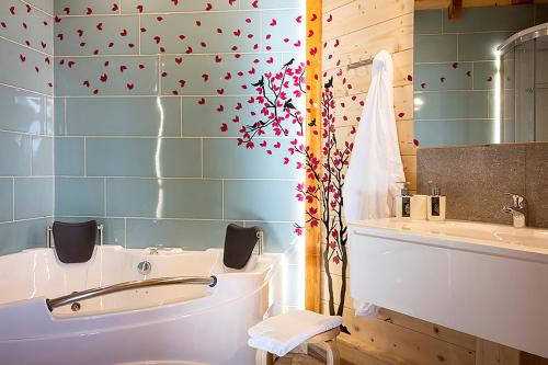 a bathroom with a blue tiled wall with hearts on it at DalaiLama Village in Antey-Saint-André
