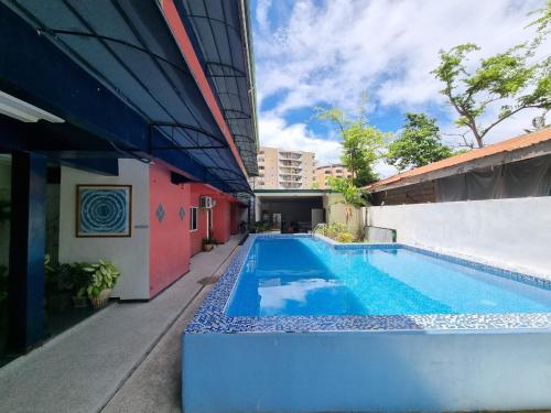 a swimming pool in front of a building at Harang Hotel Mactan Lapulapu City Cebu Philippines in Maribago