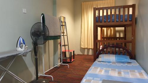 Кровать или кровати в номере EA Homestay Lembah Bujang Merbok