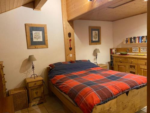 a bedroom with a bed and a sink in a room at Chalet les Chouettes in Thônes