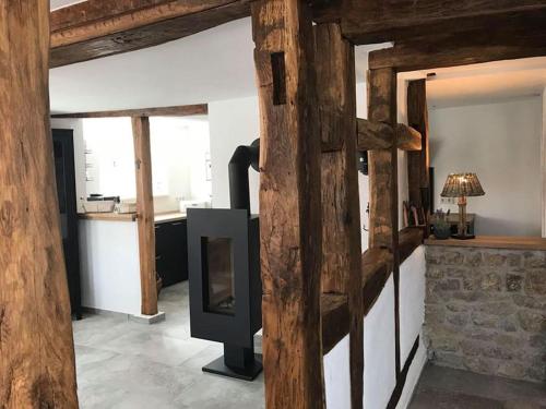 a living room with a wooden door with a fireplace at Altes Grabenhöfchen - 5 Sterne Ferienhaus in Stetten