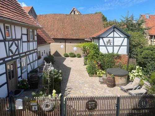 a courtyard of a house with a fence at Altes Grabenhöfchen - 5 Sterne Ferienhaus in Stetten