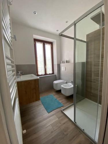 a bathroom with a shower and a sink and a toilet at Casa Mirta in Mandello del Lario
