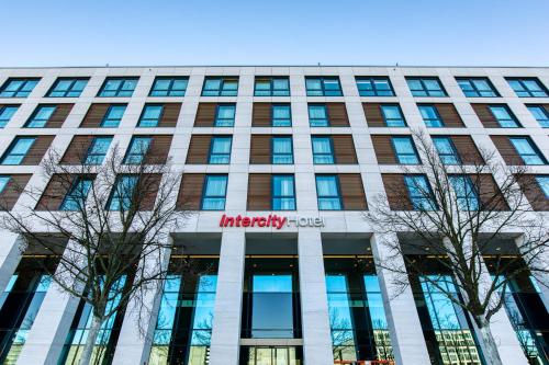 a building with a sign on the front of it at IntercityHotel Berlin Airport BER Terminal 1 & 2 in Schönefeld