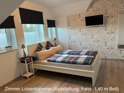 sypialnia z łóżkiem i kamienną ścianą w obiekcie Pension Blaue Nordseewelle w mieście Neuharlingersiel