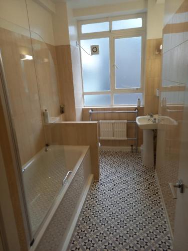 a bathroom with a shower and a tub and a sink at Heart of the city. Perfect for attractions & West End in London