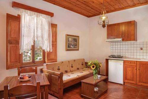 a living room with a couch in a kitchen at Apolafsis Studios in Patmos