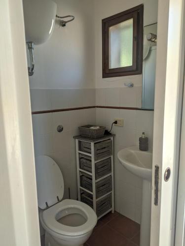 a bathroom with a toilet and a sink at Masseria Vagone in Macchia di Monte