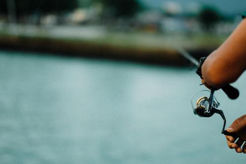 a person holding a pair of keys in their hand at Baan Tah On The Sea in Bang Sare