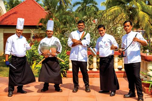 a group of chefs posing for a picture together at Caravela Beach Resort in Varca