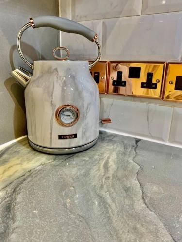 a white toaster sitting on top of a counter at Bury St Edmunds - Apartment - Sleeps 2 - Parking in Bury Saint Edmunds