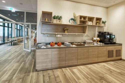 a kitchen with a counter in a building at IntercityHotel Berlin Airport BER Terminal 1 & 2 in Schönefeld