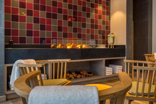 a restaurant with a table and chairs and a counter at IntercityHotel Berlin Airport BER Terminal 1 & 2 in Schönefeld