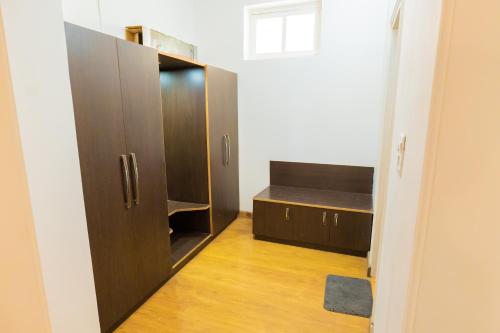 a room with a large wooden cabinet and a desk at Neelesh Inn- A Luxury Lake View Hotel- 20 kms from Nainital in Bhīm Tāl