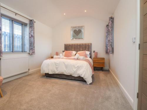 a bedroom with a bed and a window at Skirden View in Clitheroe