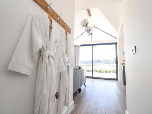 a bathroom with white towels hanging on a wall at Skirden View in Clitheroe