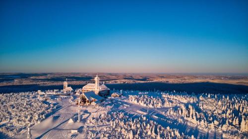 an aerial view of a ski resort in the snow at Fichtelberghaus in Kurort Oberwiesenthal