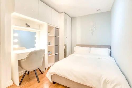 1 dormitorio con cama, escritorio y silla en Luxury app in central Welwyn Garden, sleeps 4, en Welwyn Garden City