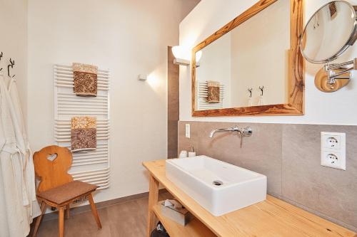 a bathroom with a sink and a mirror at Ferienwohnung Dosbach in Reit