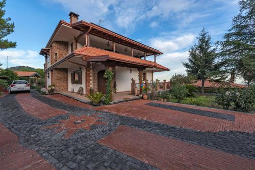 a house with a brick driveway in front of it at Etna Casa del Sole in Nicolosi