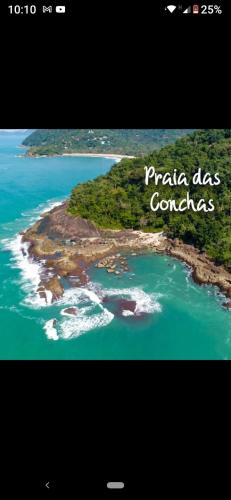 an island in the ocean with the words praia dos comales at Apts centro Ubatuba in Ubatuba
