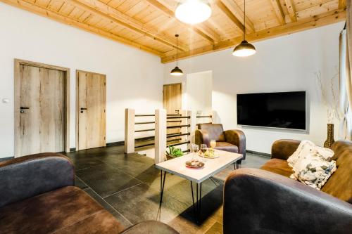 a living room with couches and a table at Penzion Zvon in Horní Stropnice