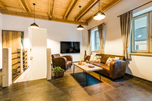 a living room with a couch and a table at Penzion Zvon in Horní Stropnice