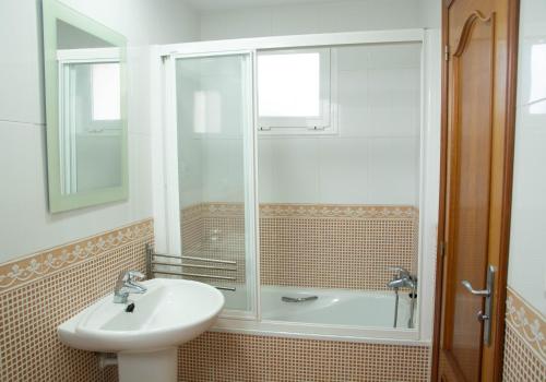 een badkamer met een wastafel en een douche bij Kione Bellamar in Alcossebre