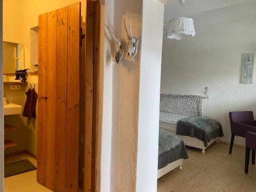 a room with a bedroom with a bed and a door at Traubengarten Winkler in Niederhollabrunn